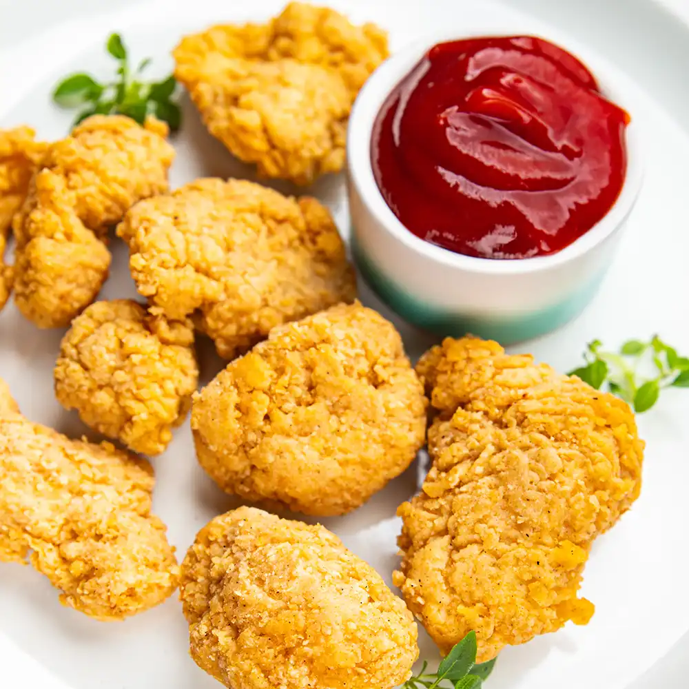 Plate with popcorn chicken and ketchup